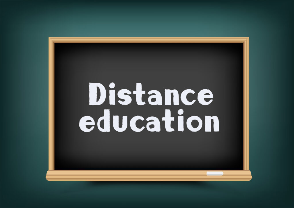 distance education written on a digital black board