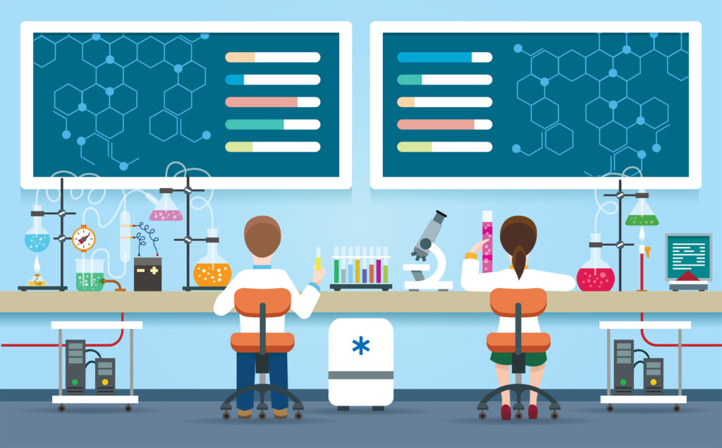 two scientists sit side by side in a science lab